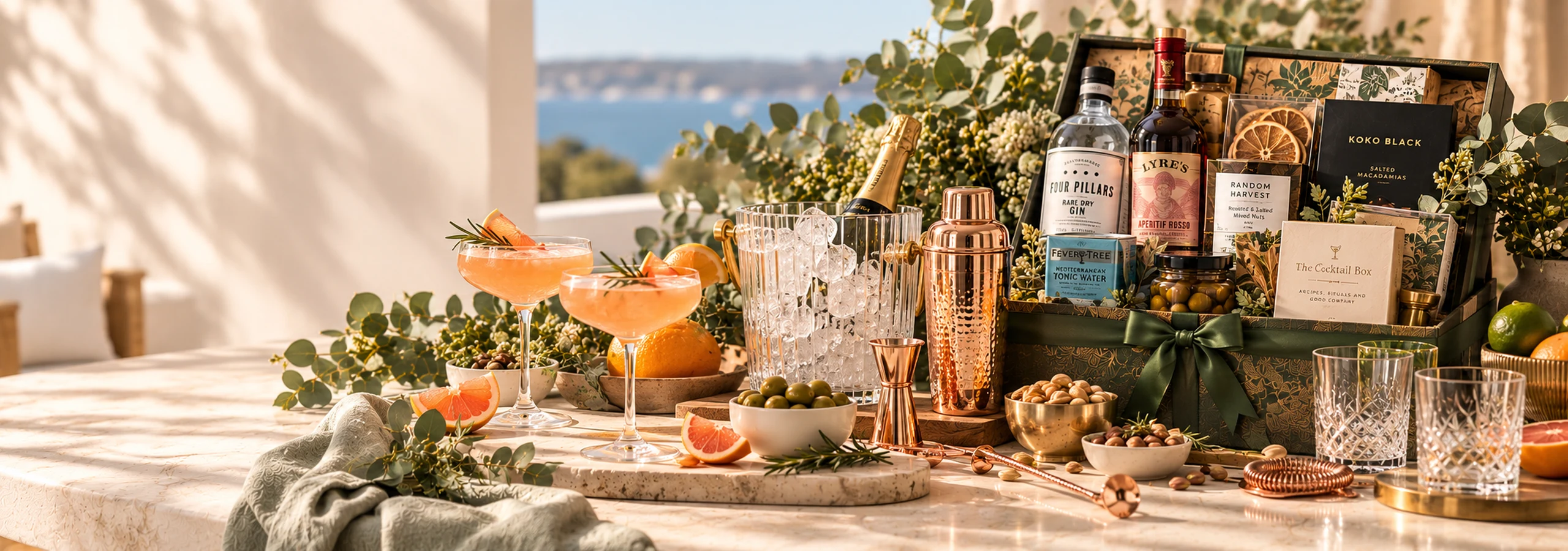 Cocktail gift setting with gin, aperitif, mixers, cocktail glasses, shaker, citrus and gourmet accompaniments