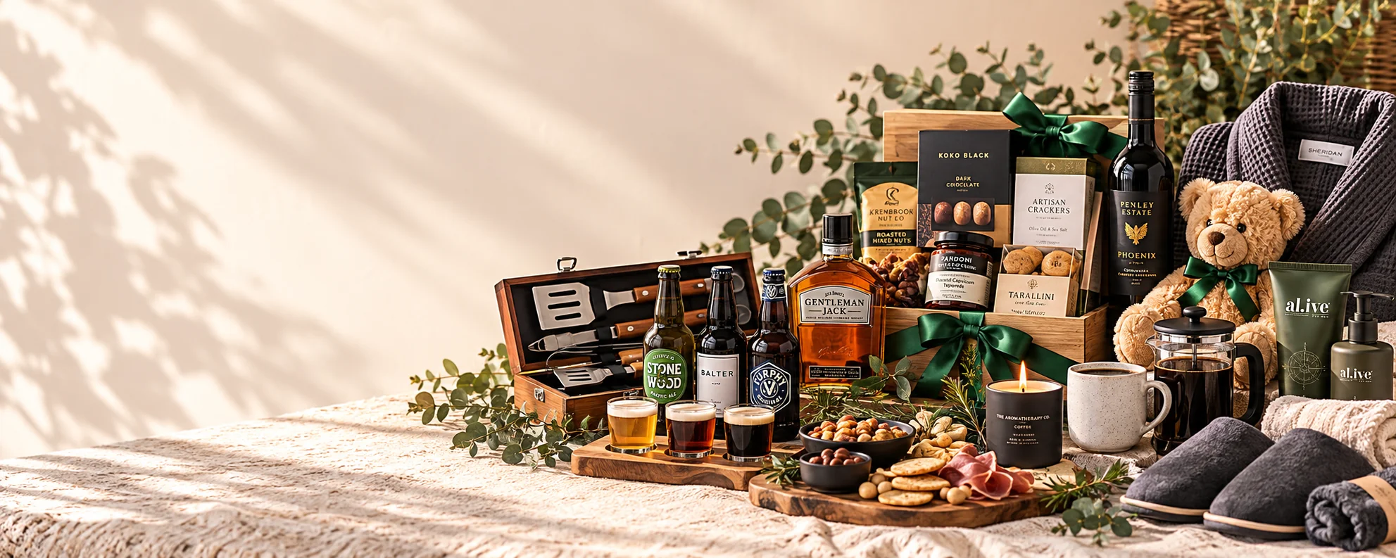 Gifts for men setting with gourmet treats, wine, whisky, craft beer, barbecue tools, coffee and pampering gifts